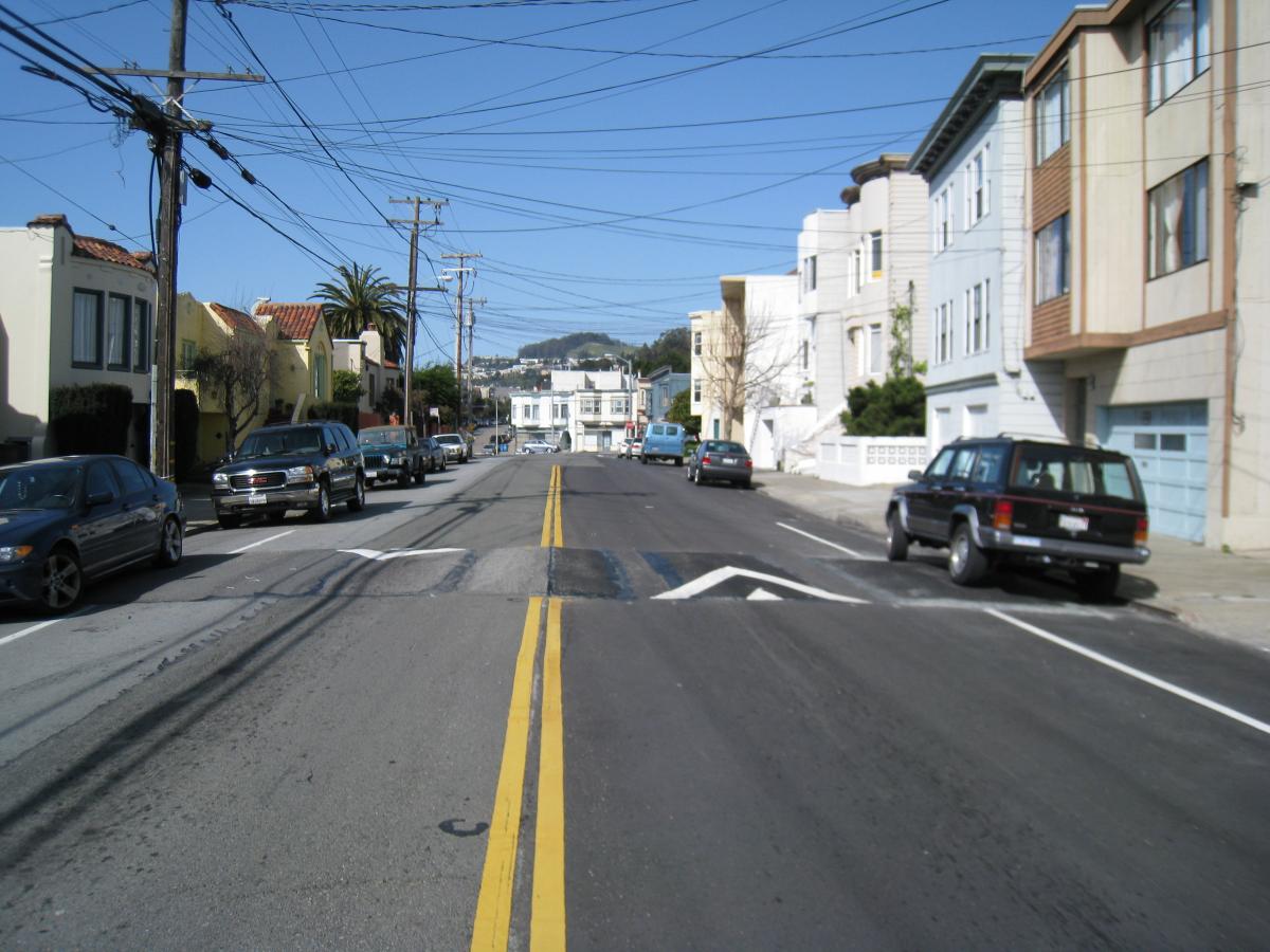 Image of a two-lane roadway with Speed Cushions in the middle of the block.