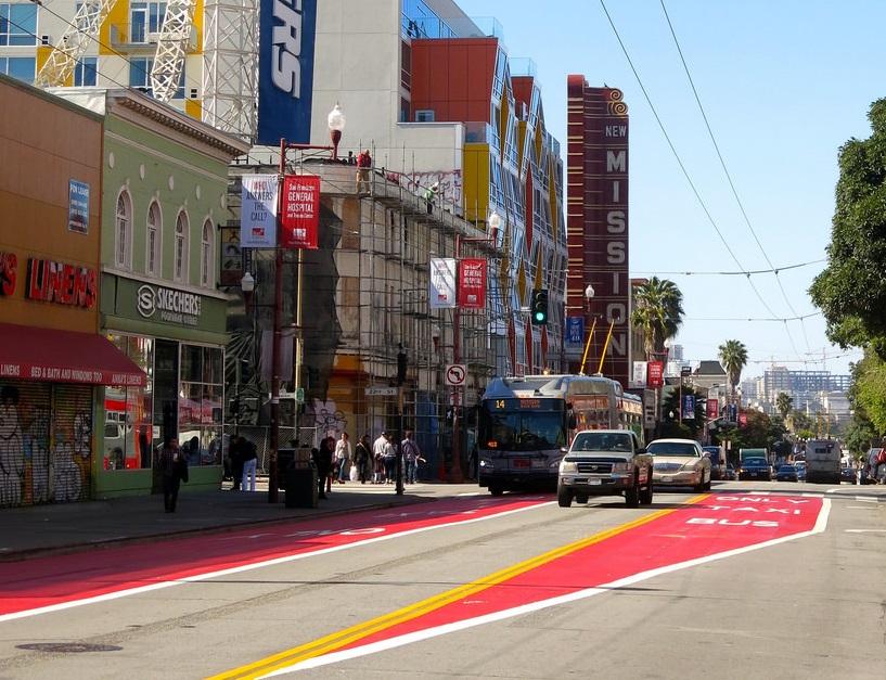 Mission Street red transit lane with Muni bus and surrounding urban storefronts
