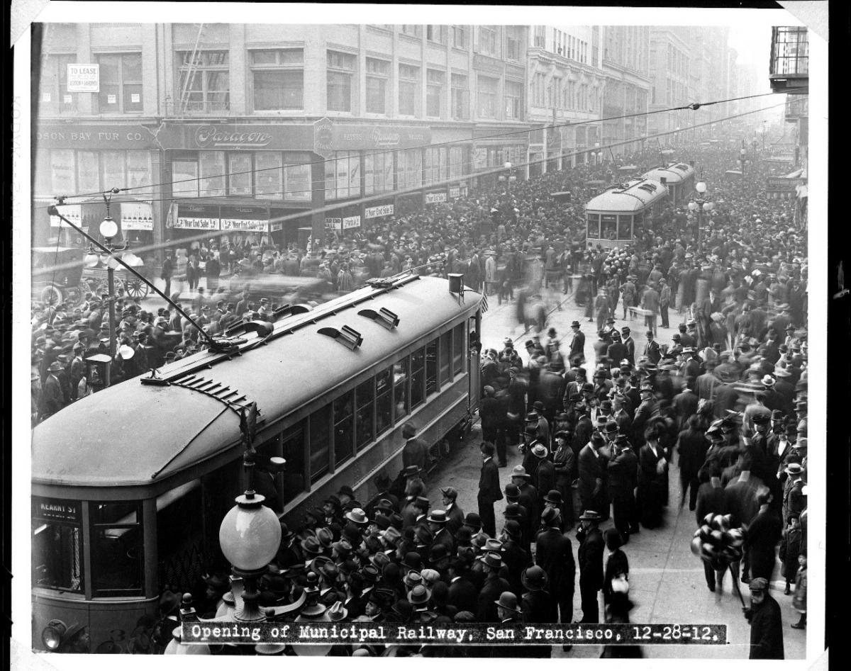 Photo of crowd surrounding two Muni streetcars in downtown San Francisco in 1912