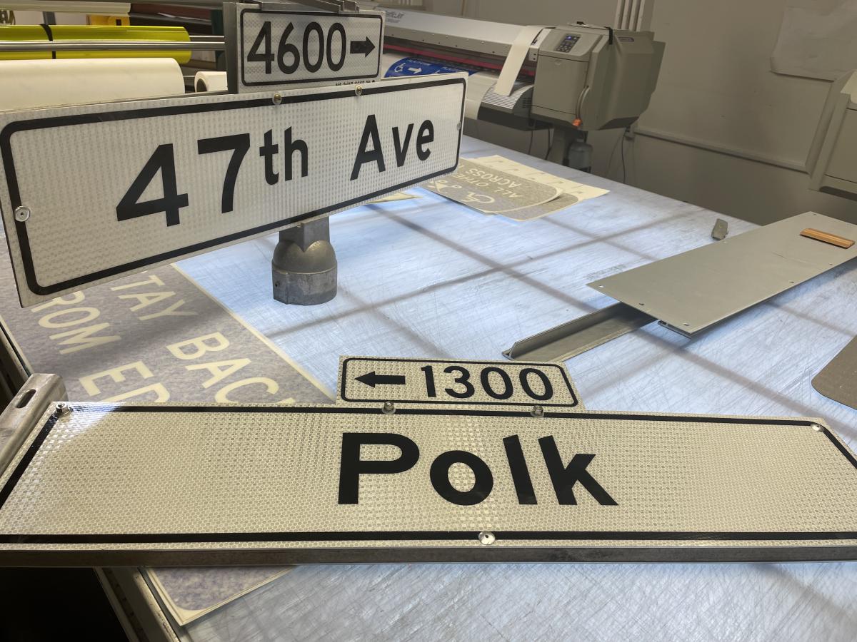Two street signs on a table