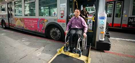 Customer disembarks a bus using the wheelchair ramp