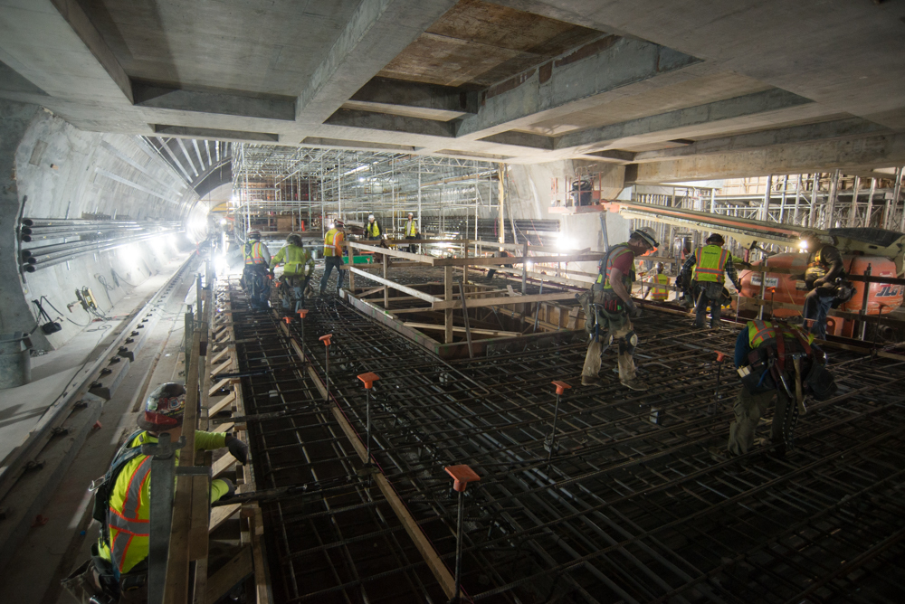 Workers put the finishing touches on rebar installation to complete construction of the Chinatown Station platform slab.