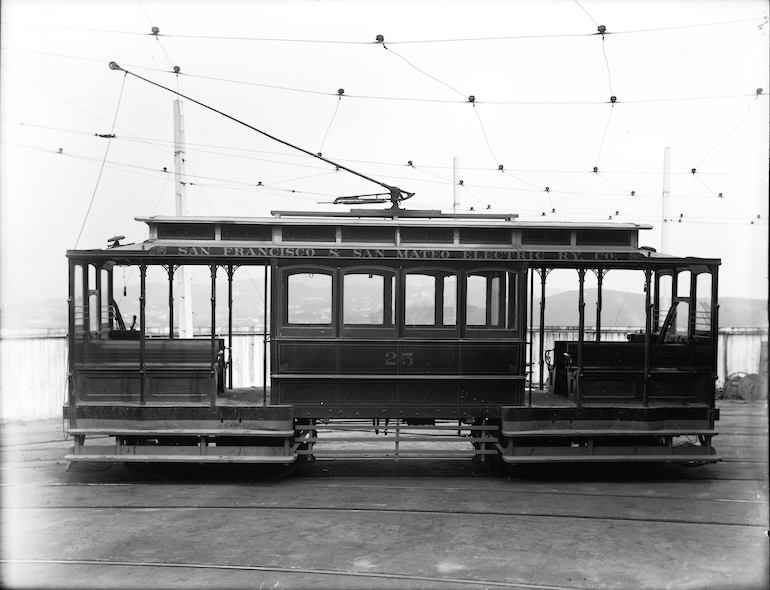 Black and white photo showing the side of an electric streetcar in 1903.