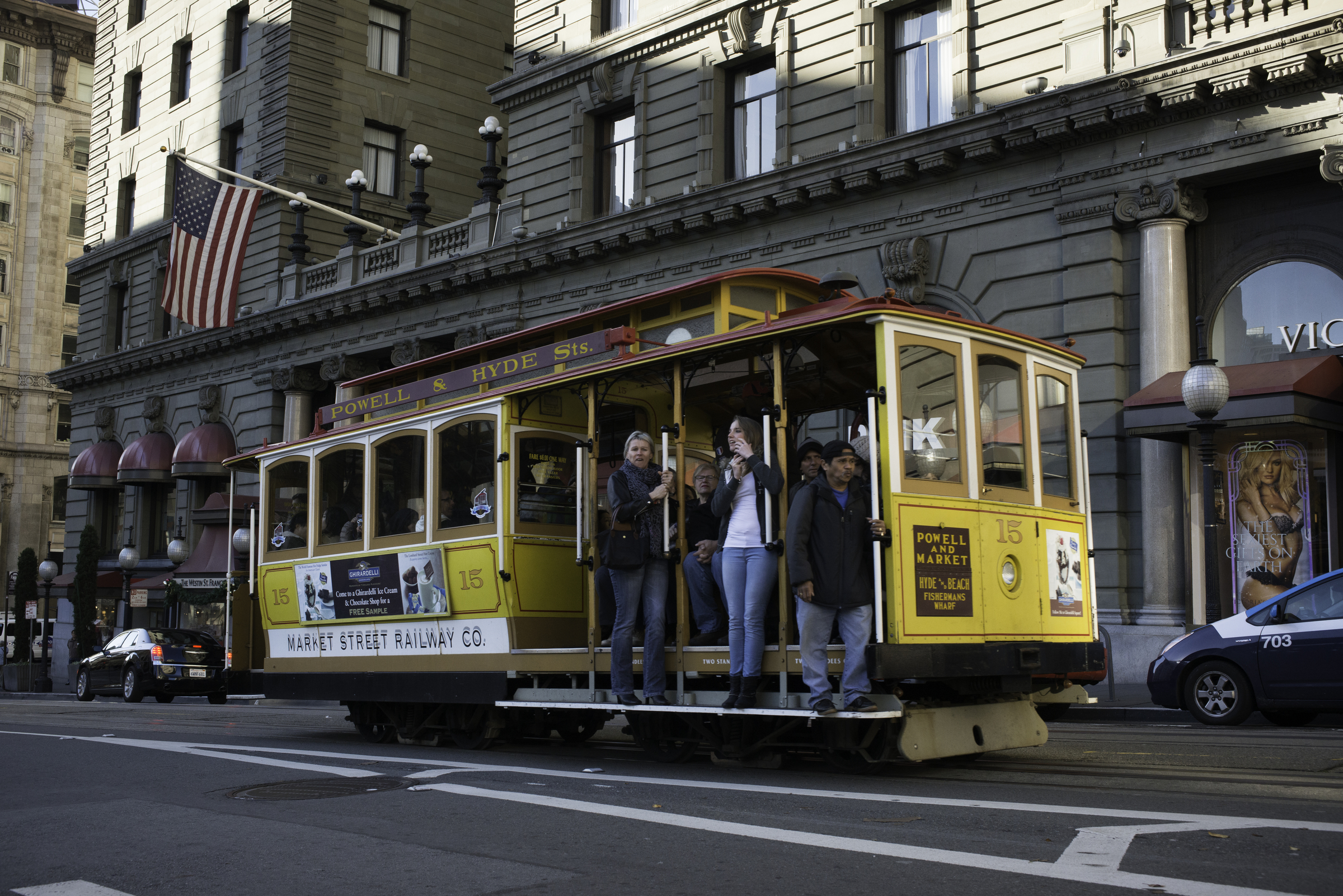 The yellow cable car 15 rumbles north past the Westin St. Francis Hotel on Powell Street.