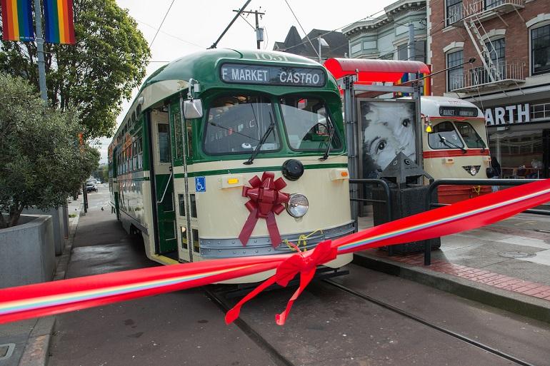 Creme and Green Livery Street with a red bow on the front behind a red ribbon.