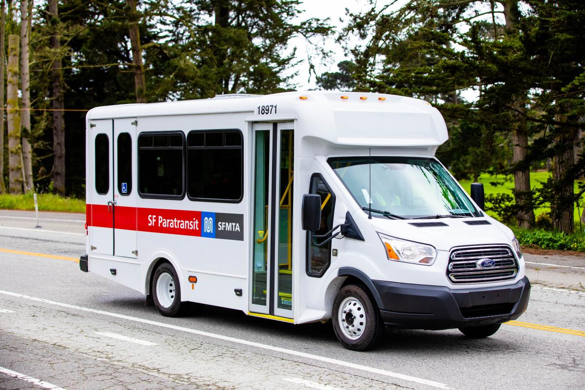 A Ford paratransit van drives through Golden Gate Park