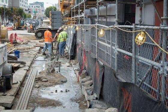 At the Yerba Buena/Moscone Station site, workers are using pipes built into each wall section to inject grout into the soil beneath them.