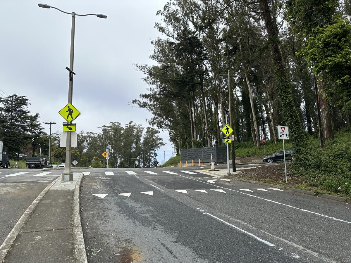 Newly isntalled signs for Rapid rectangular flashing beacon and crosswalk at Dellbrook and Clarendon