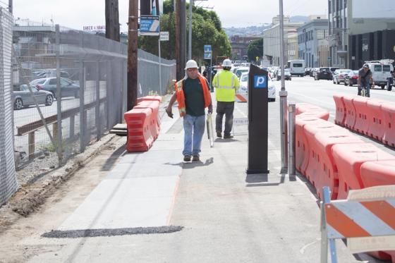 Image of ongoing utility work has been covered over with temporary wooden walkways. 