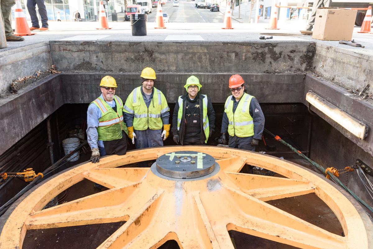 Crew stands next to a fully rehabilitated sheave lowered into place.