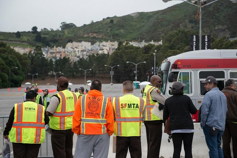 SFMTA staff and spectators observe a transit operator preparing for the roadeo safety course competition.