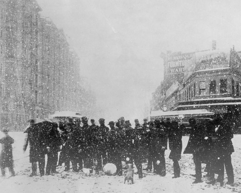 Group of people gathered on snowy Market Street during heavy snowfall, circa 1882.
