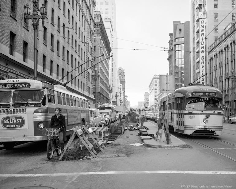 Streetcars and buses navigate around construction on Market Street, San Francisco, 1966.