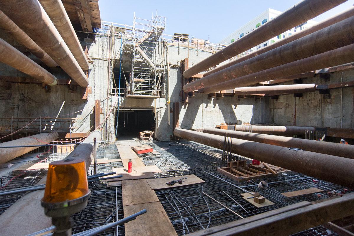 Construction site showing reinforced concrete rebar framework being installed in transit station headhouse.