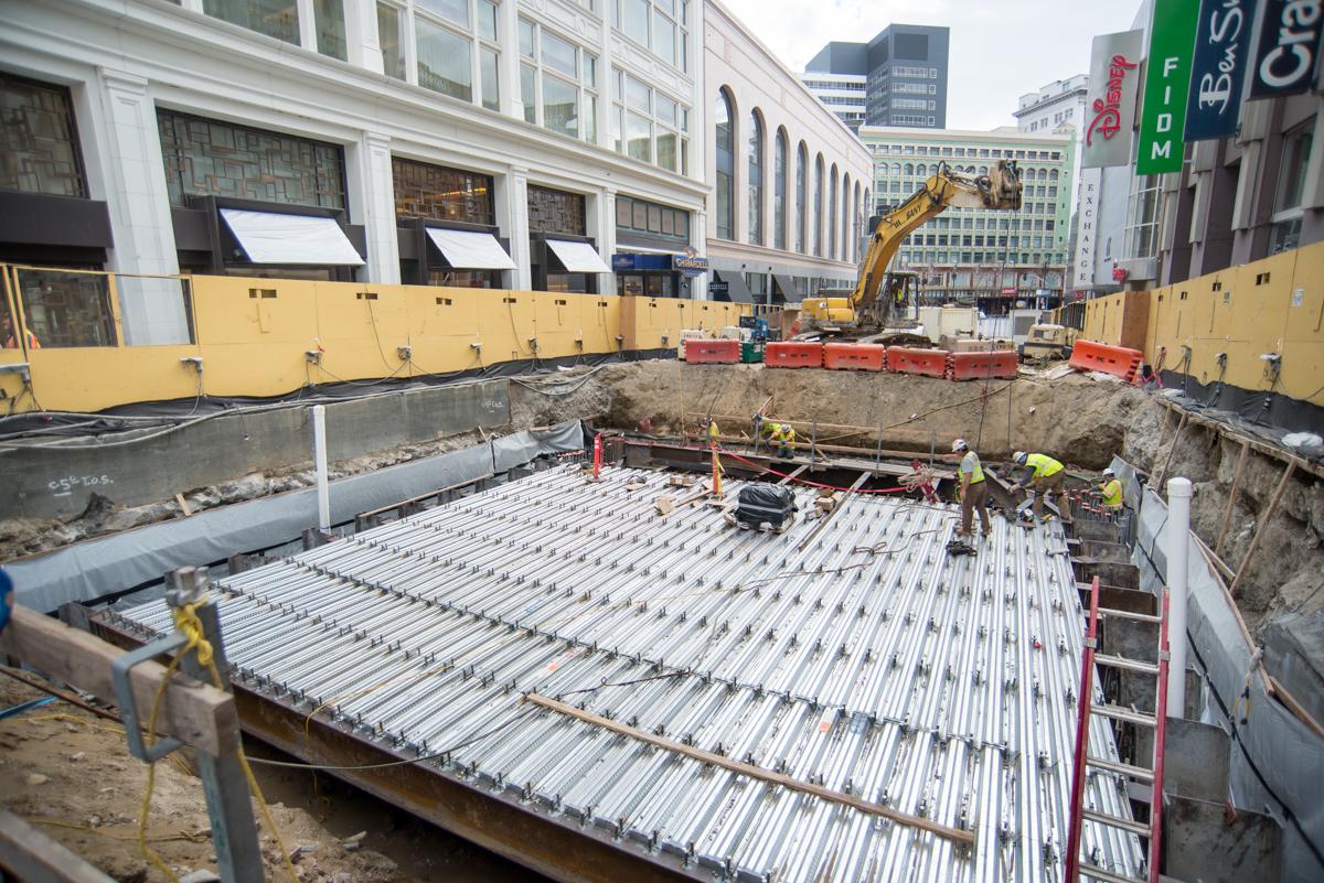 Construction site showing steel deck installation for Central Subway station box on Stockton Street, San Francisco.