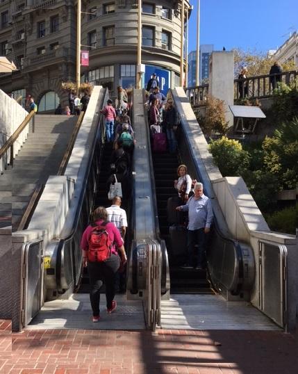 Image of people coming down a muni metro escalator at Hallidie Plaza