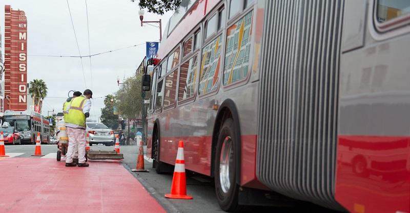 Crews putting down red transit lanes in the Mission