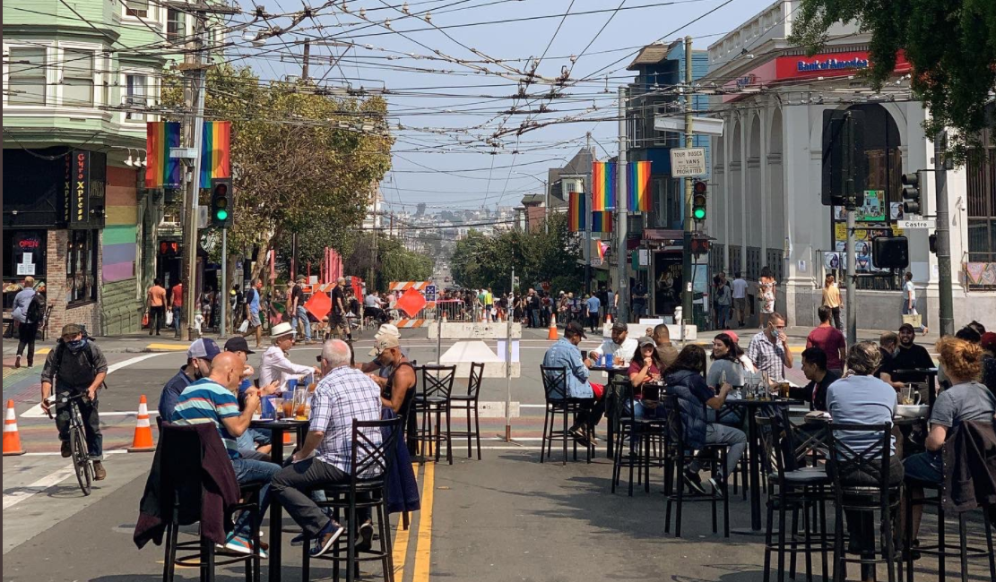 People enjoy the Shared Space at 18th and Castro streets