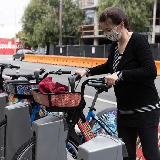 Woman using bikeshare station