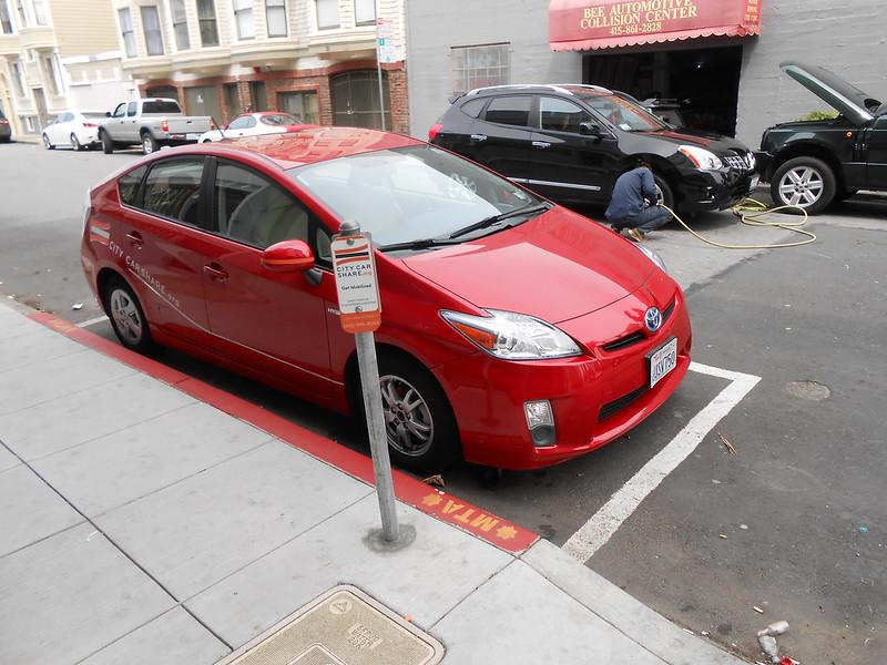 A shared vehicle parked at a permitted car share only curbside parking space.