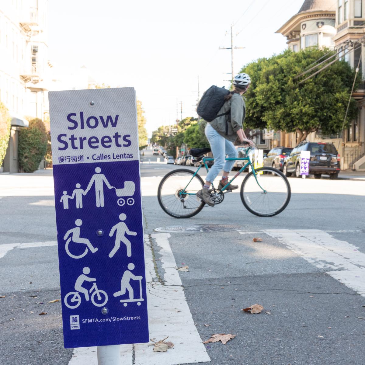 Cyclist rides across a Slow Street
