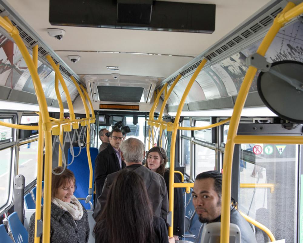 people looking at artwork in bus
