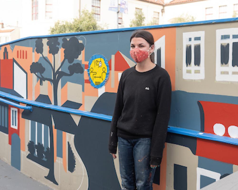 Artist Emily Fromm with her mural "East West Portal"