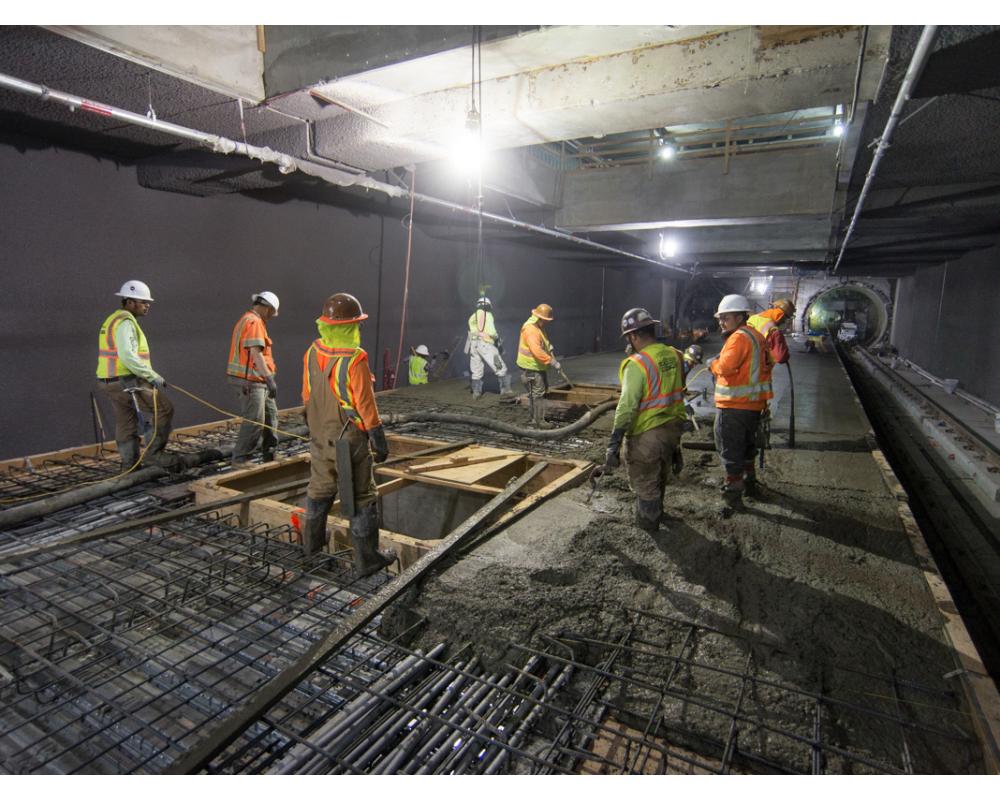 A crew pours concrete around future elevator footings inside the Yerba Buena/Moscone station box.