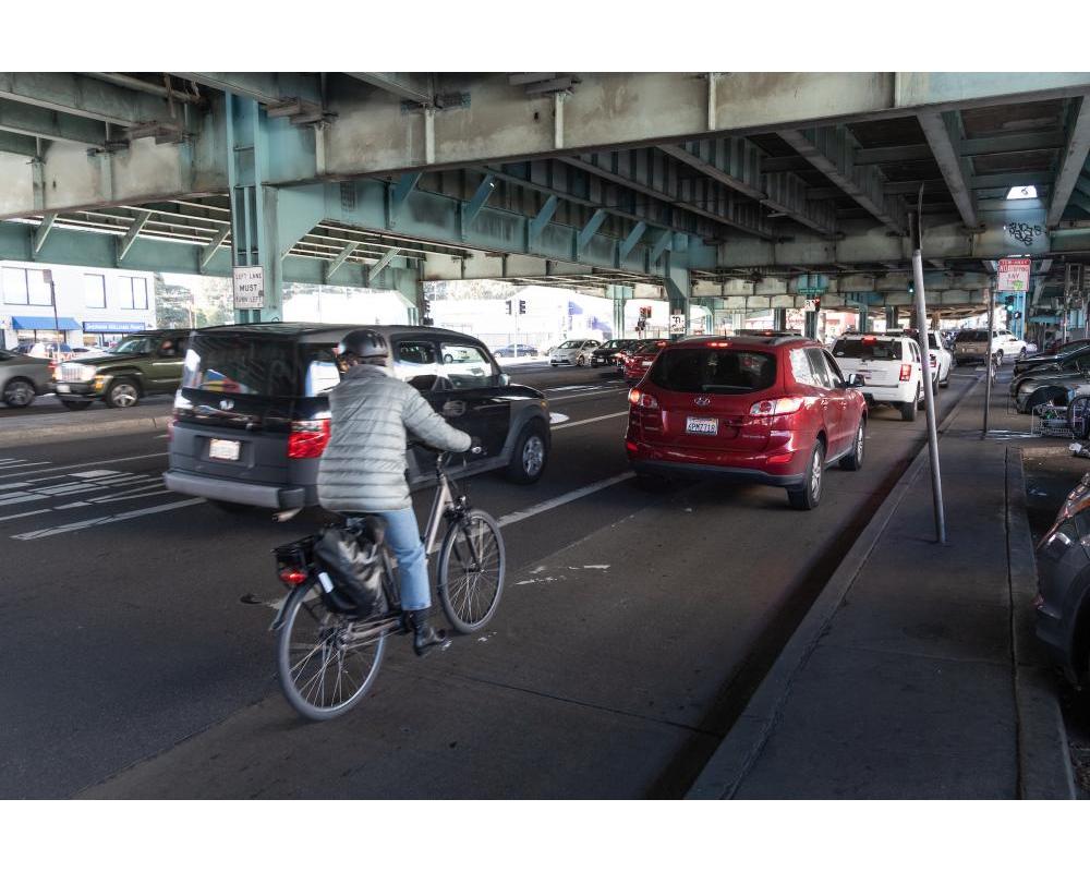 a bicyclist rides in mixed traffic