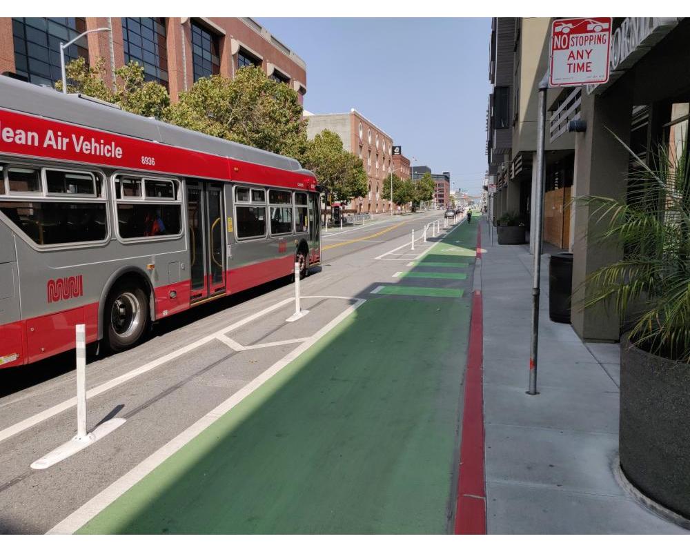 Photo of protected bikeway between 7th and 8th streets with Muni bus driving by - September 2020