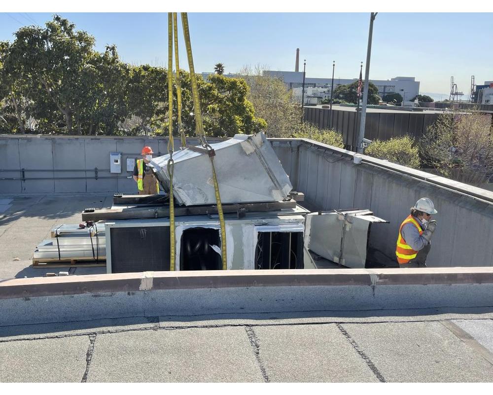 Workers installing new air handlers 