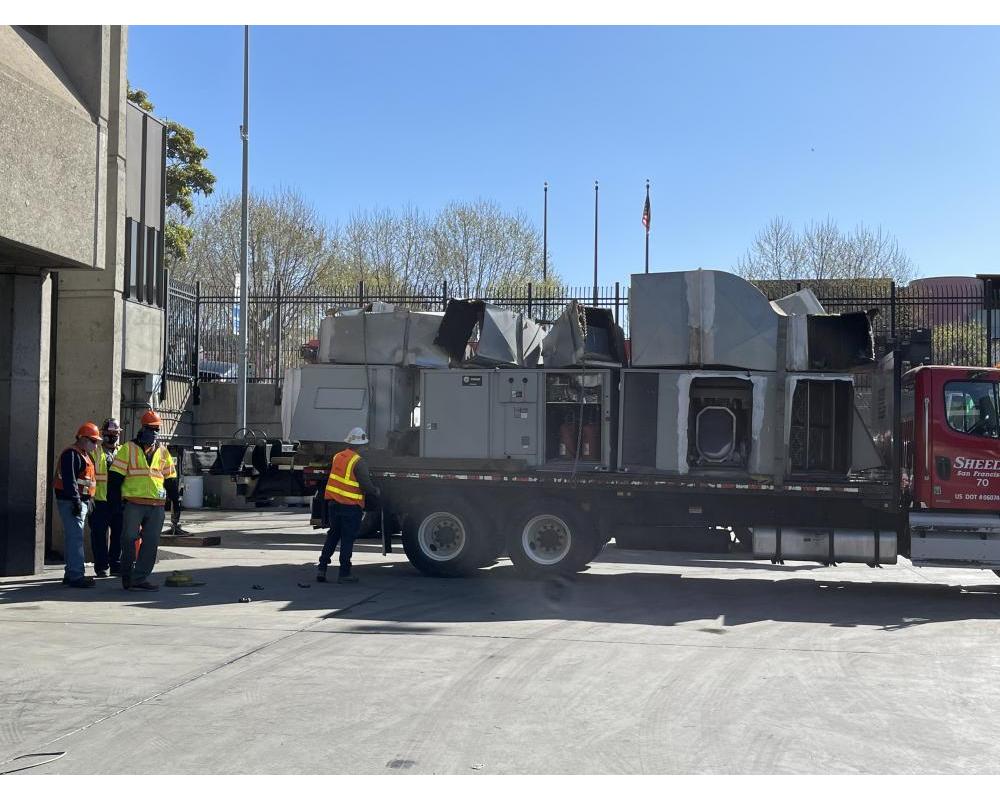 Workers installing new air handlers 