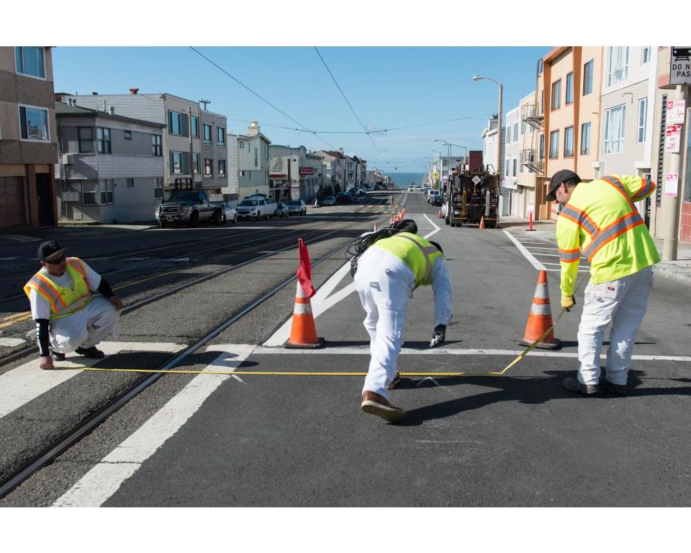 Photo of crew painting new safety striping on Taraval Street