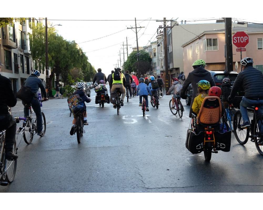 Kids and people biking on Page Slow Street on their way to school