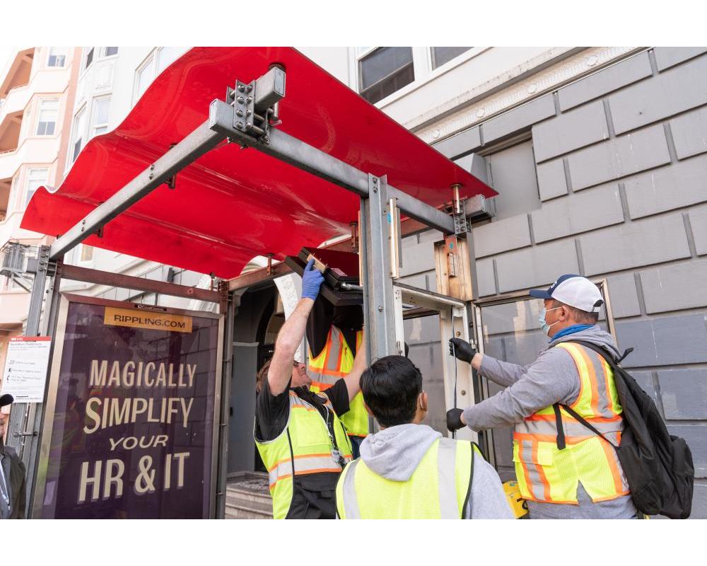 Crews installing the new customer information sign 