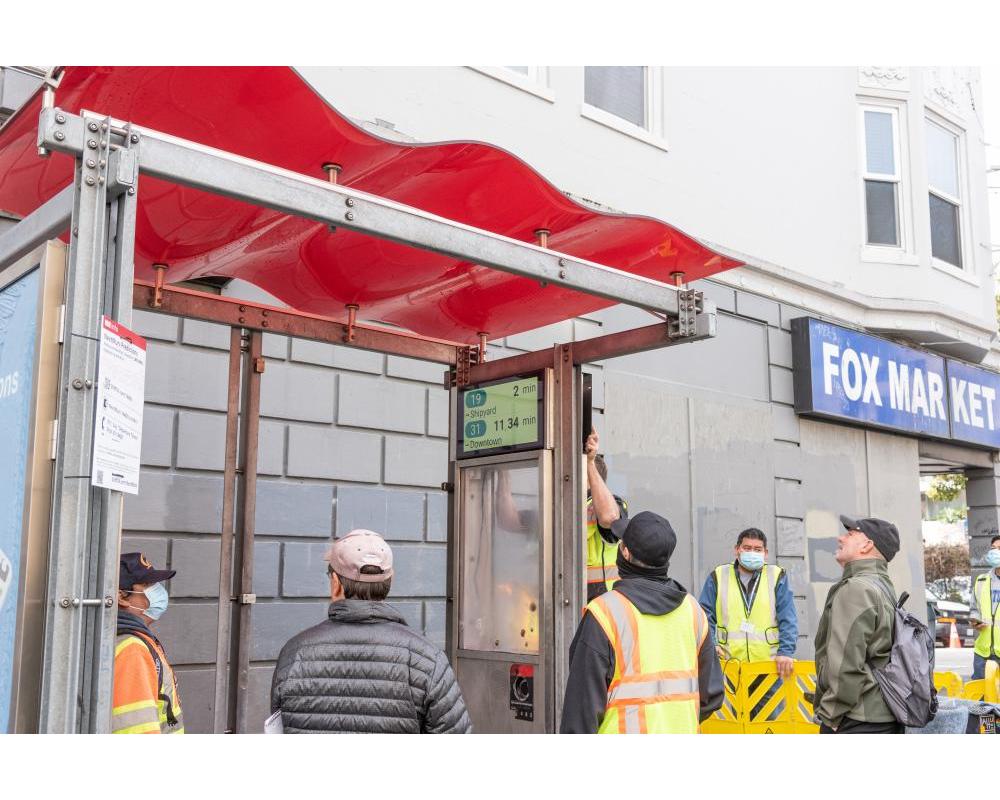 Crews installing the new customer information sign 