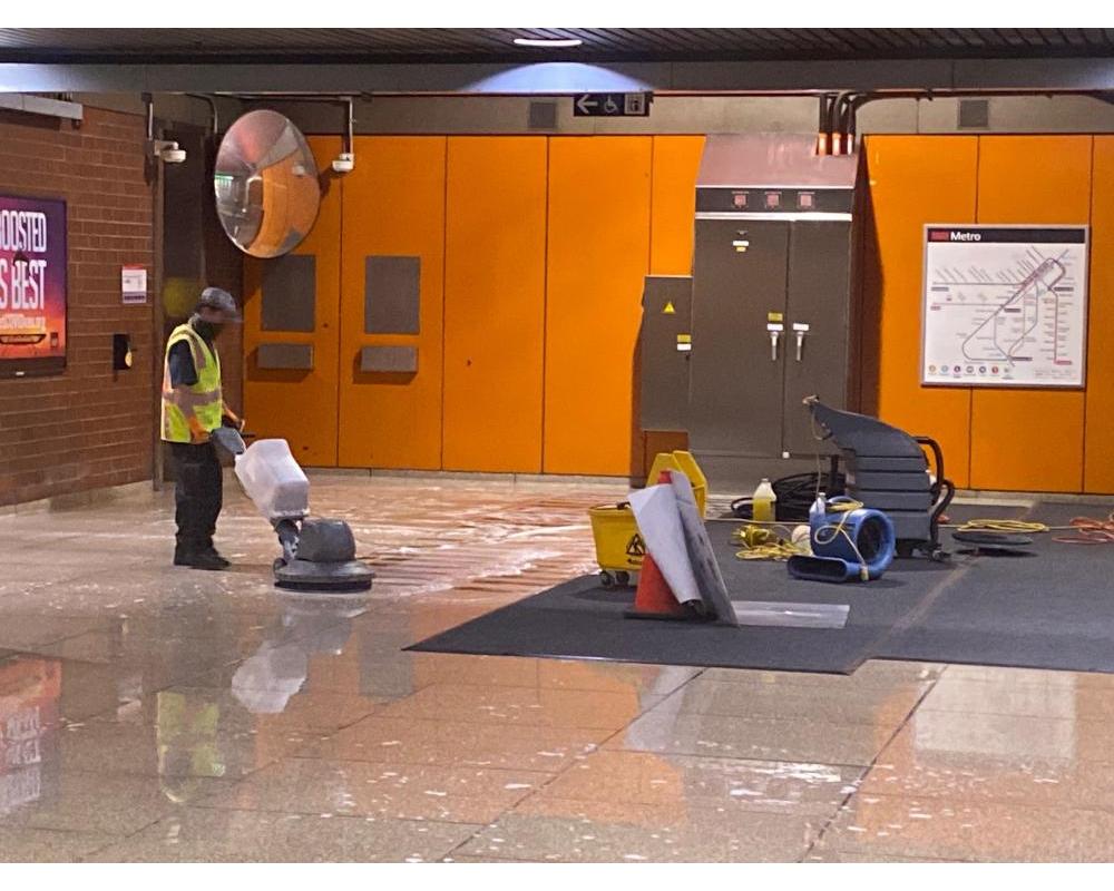 Custodians from Buildings and Grounds make the floor shine at Castro Station