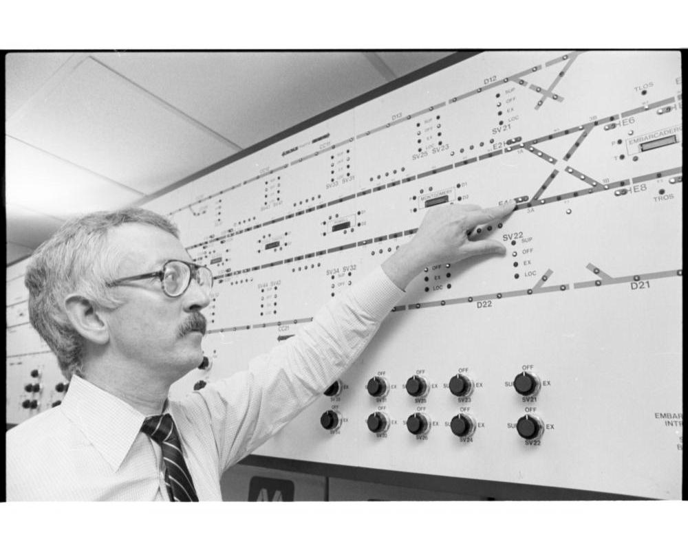 Man pointing at a train management panel