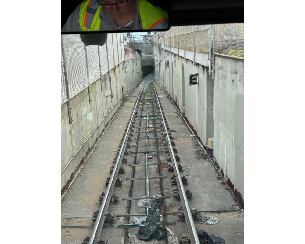 Muni Metro train tracks leading into a tunnel opening