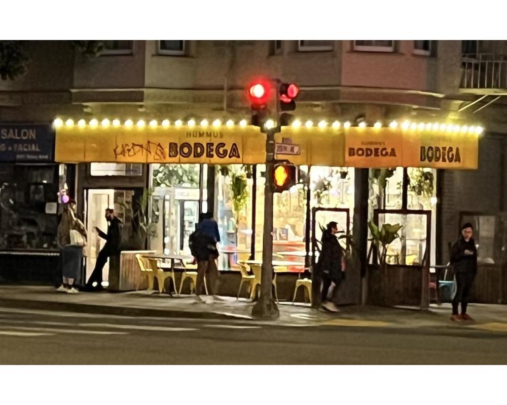 Decorative lighting above the awning for Hummus Bodega on Geary.