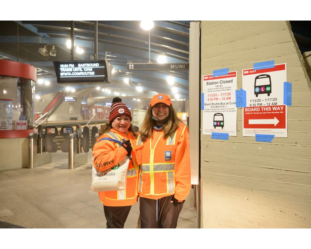 Ambassadors at West Portal Station assisting customers with wayfinding.