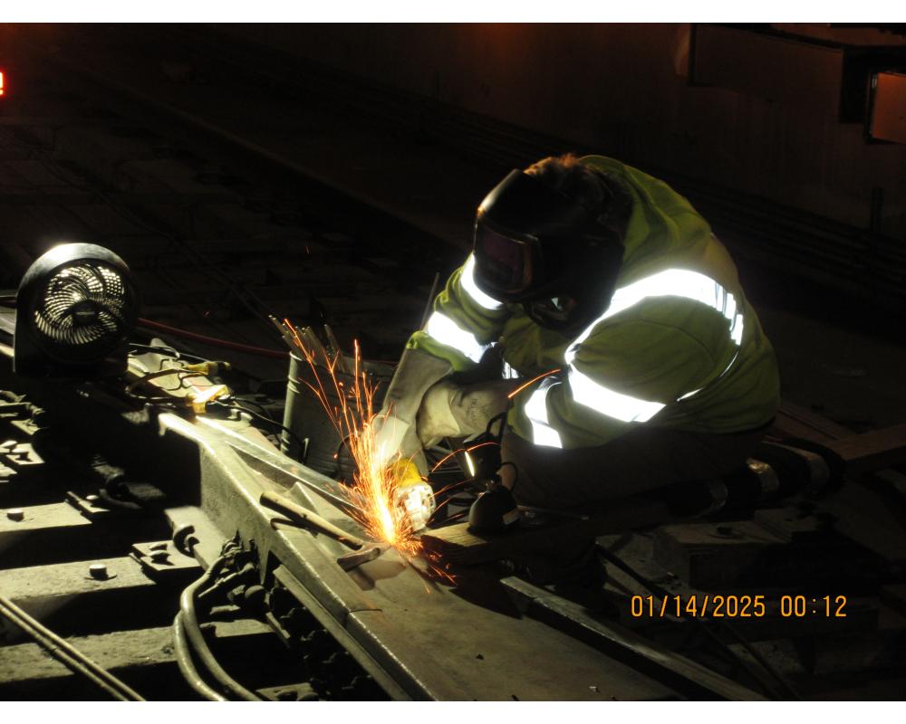 SFMTA staff completes track work on Van Ness Station, carrying out welding repairs.