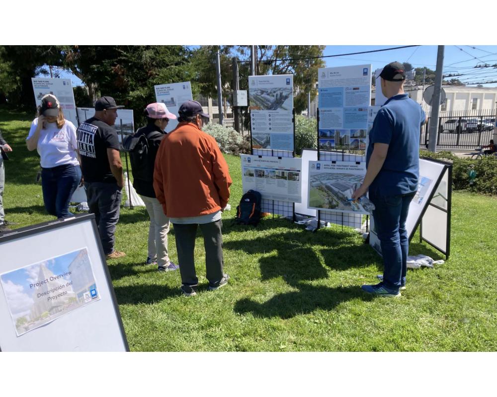 a group of people in a park setting view informational boards