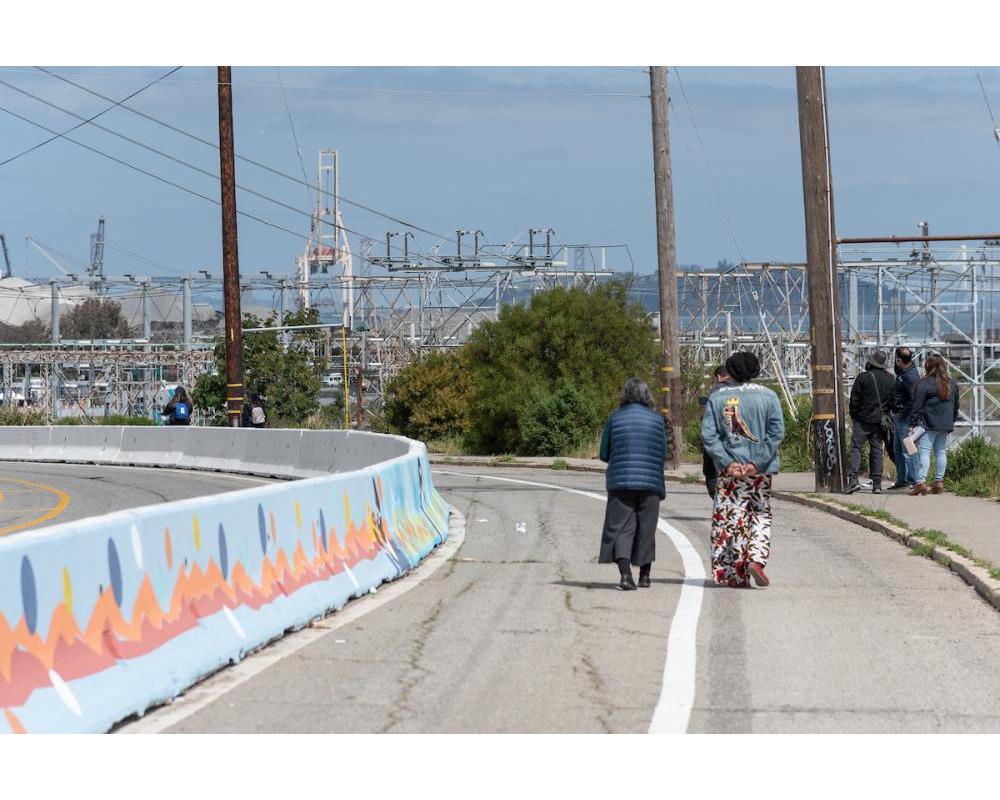 Pedestrians walking along Hunters Point Bouelvard