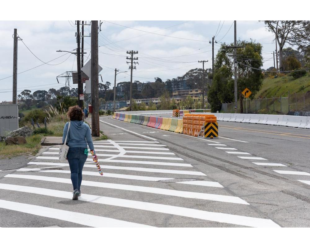 Pedestrian walking along Evans Avenue