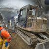 Workers use a shotcrete spraying machine inside the top header of the north platform cavern of Chinatown Station.