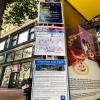 Photo of face mask, wayfinding and ETC signs at a bus stop on Market Street.