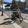 person riding a pedicab along the Embarcadero