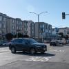 Image of car turning onto Commonwealth at Geary, with new traffic signal in the background