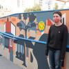 Artist Emily Fromm with her mural "East West Portal"